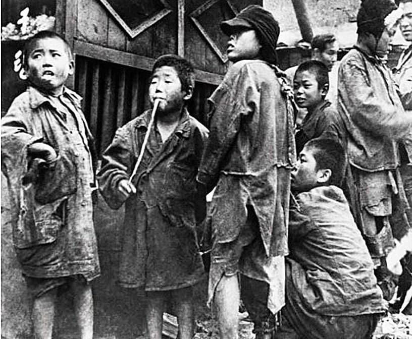 A group of Korean children in torn, filthy clothing
